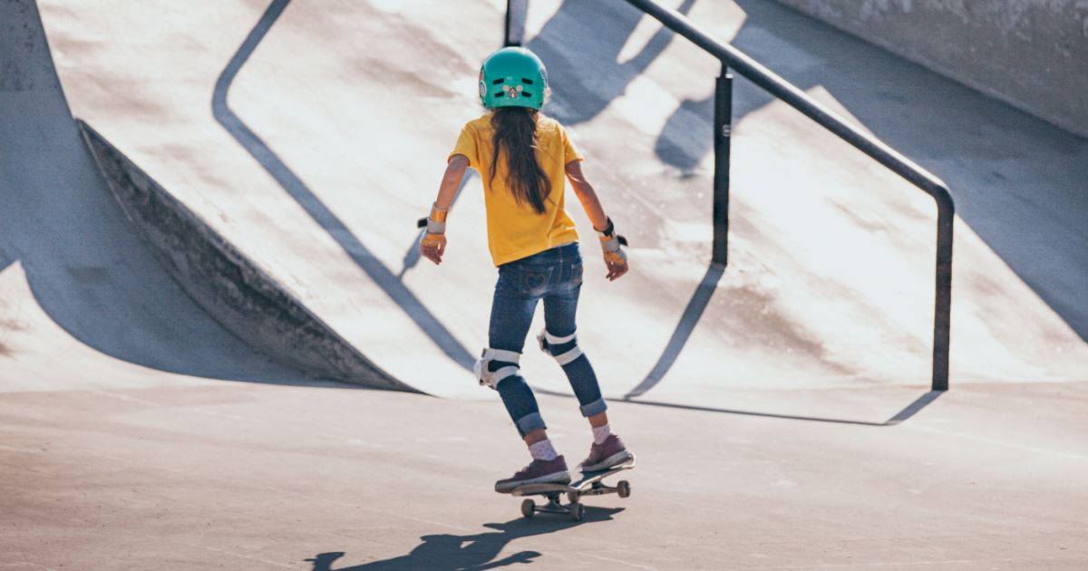 Young Girl Skateboarding in Public Skateboard Park